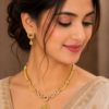 Traditional gold tone necklace set with matching earrings for wedding, festive and ethnic wear.