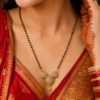 Premium Artificial AD Mangalsutra Premium artificial AD mangalsutra with black beads and floral pendant