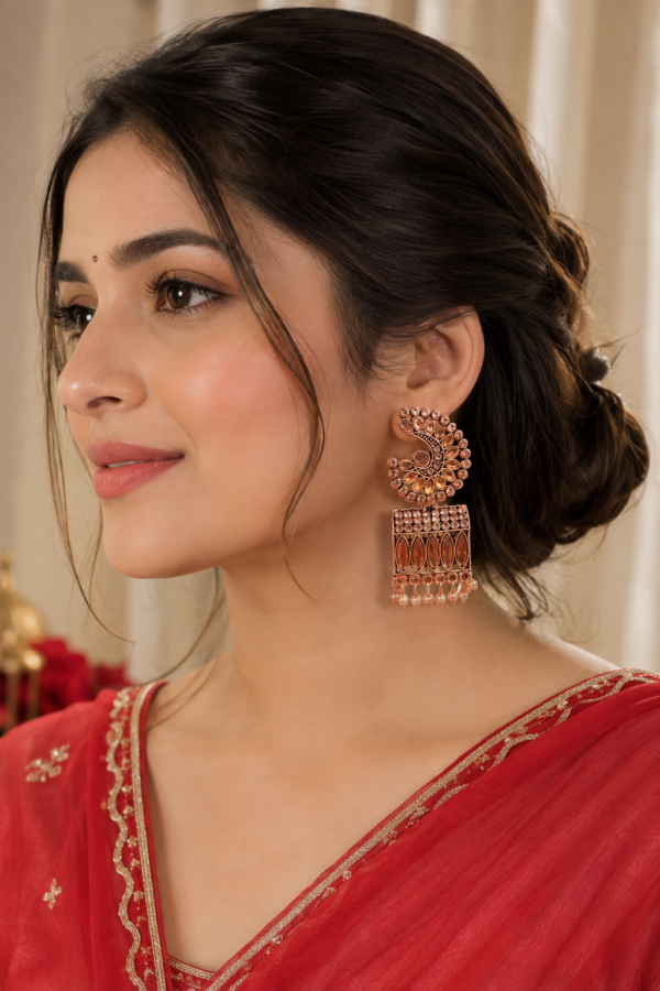 Traditional gold finish earrings with amber tone leaf detailing