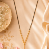 Designer Black Beaded Mangalsutra Designer black beaded mangalsutra with gold-tone Y-shaped detailing