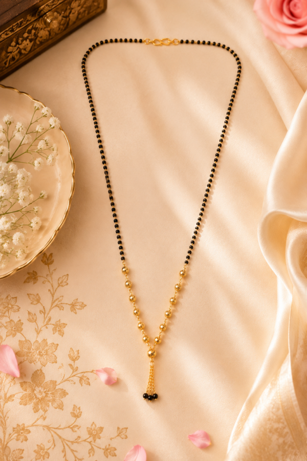 Designer Black Beaded Mangalsutra Designer black beaded mangalsutra with gold-tone Y-shaped detailing