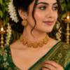 Floral Gold-Tone Necklace with Earrings Floral gold-tone necklace with decorative stone-like detailing and matching earrings