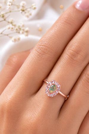 Green stone rose gold finish ring with teardrop centre design
