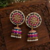 Pearl detail jhumka earrings with blue and pink patterns