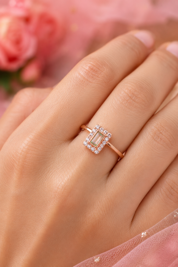 Rose Gold Tone Green Centre Ring Rose gold tone ring with elongated green centre and decorative stone accents