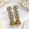 Elegant long jhumka earrings with gold-tone detailing and white accents. Gold finish long jhumka earrings with white stone detailing
