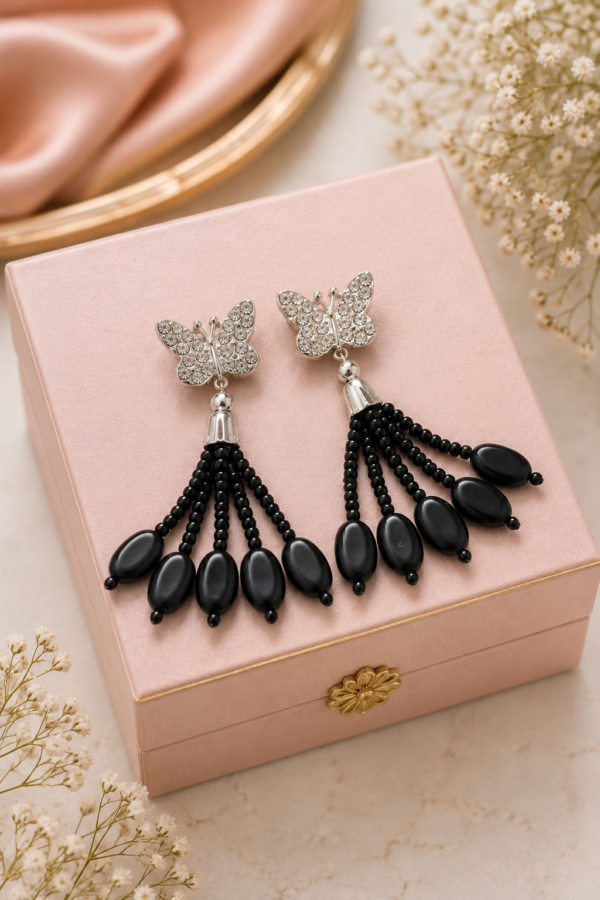 Butterfly Drop Earrings with Black Oval Beads Butterfly drop earrings with black oval beads and silver-tone detailing