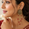 Gold tone red bead earrings worn with traditional outfit