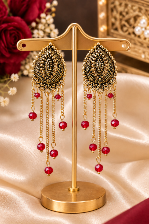 Red bead ethnic earrings with intricate gold tone design