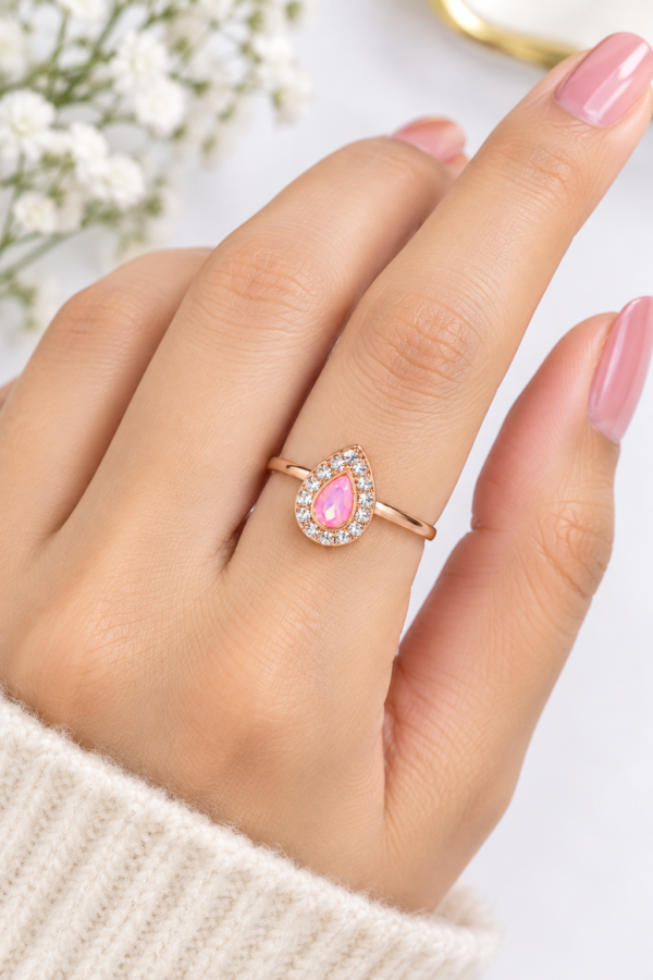 Pink Pear-Shaped Stone Ring Close-Up Close-up of pink pear-shaped stone ring with clear decorative stones