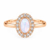 White stone ring with oval centre and sparkling halo
